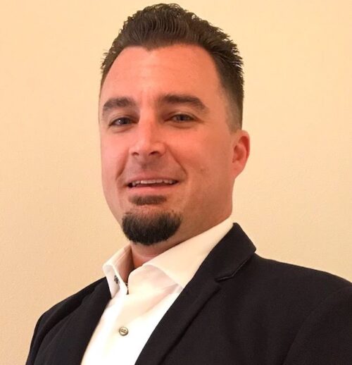 Matthew Klodt in a sport coat and a nice, white collared shirt.